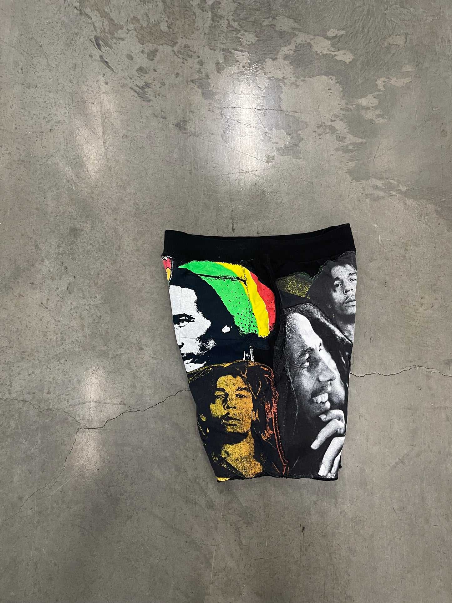 Bluesin’s “Richness Is Life Forever” Bob Marley Patchwork Sweat Shorts