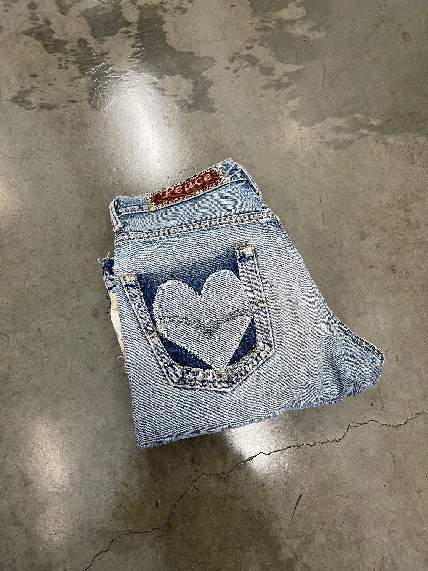 Bluesin’s “Peace Love & Healing” Patchwork Reworked Denim Jeans